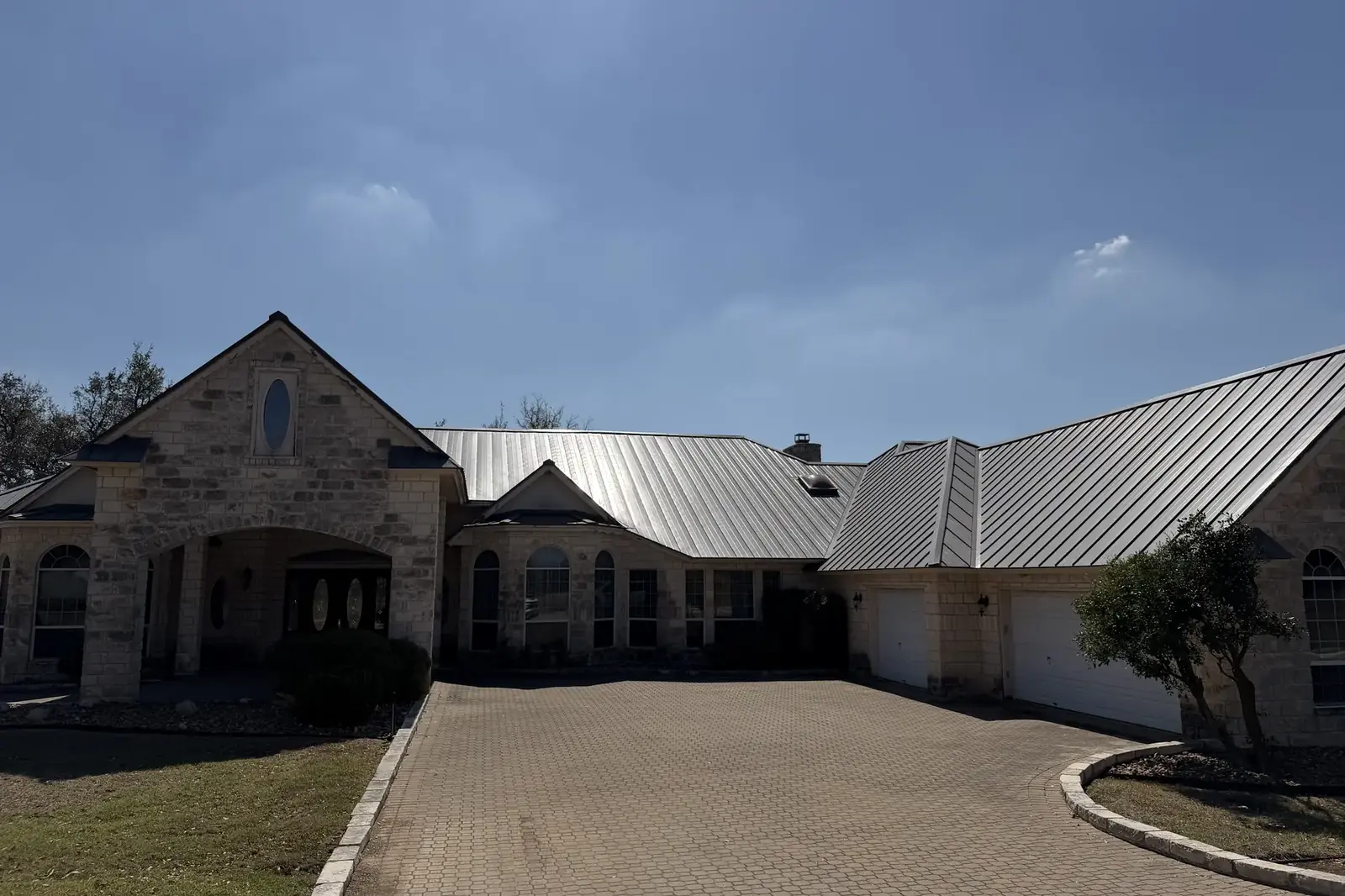 Front of the ranch lodge under a Hill Country sky